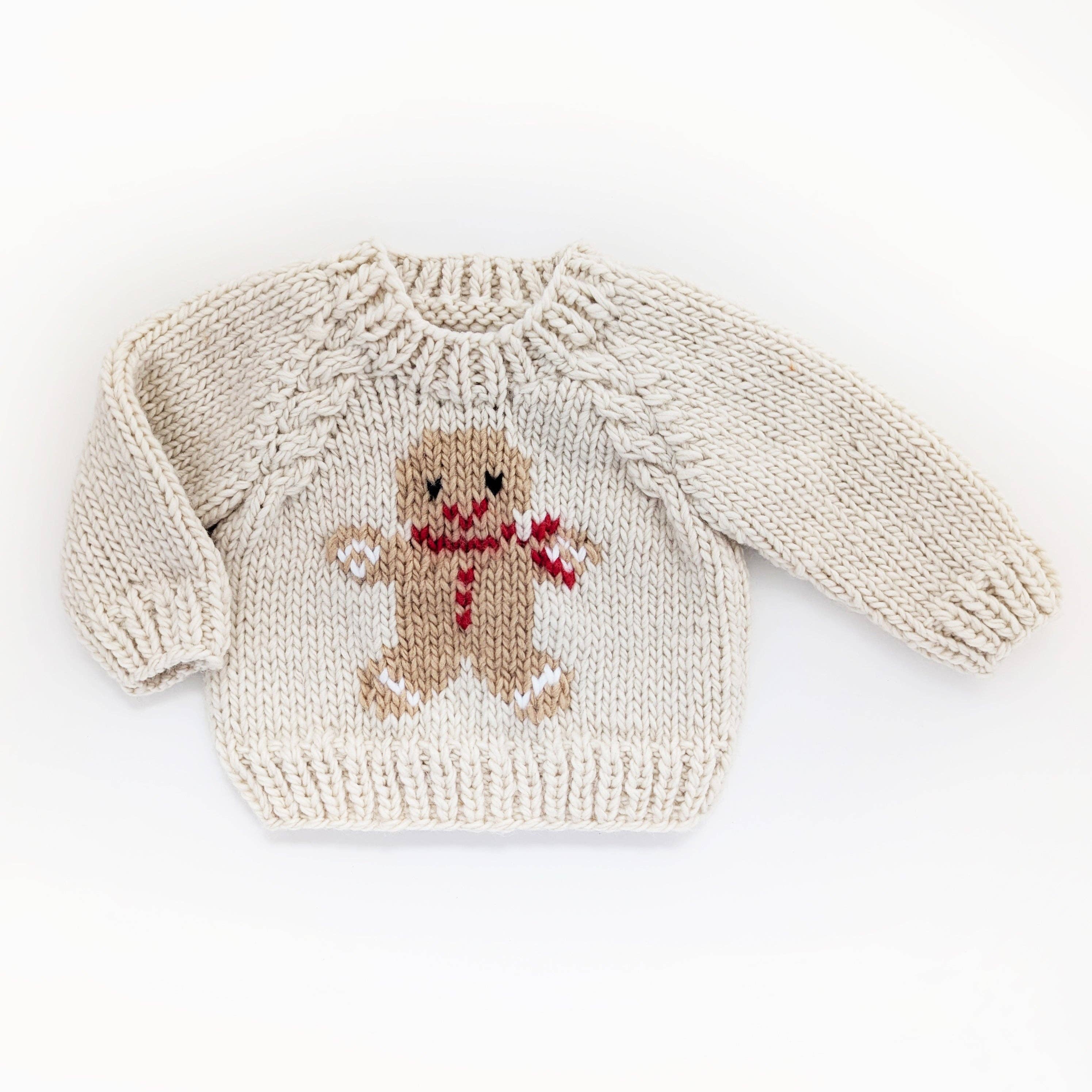 Knitted sweater with a gingerbread man design on a white background